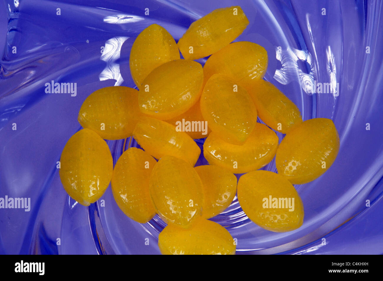 Blue glass dish with Sherbet Lemons, Urb. Calypso, Costa del Sol, Malaga Province, Andalucia, Spain, Western Europe. Stock Photo