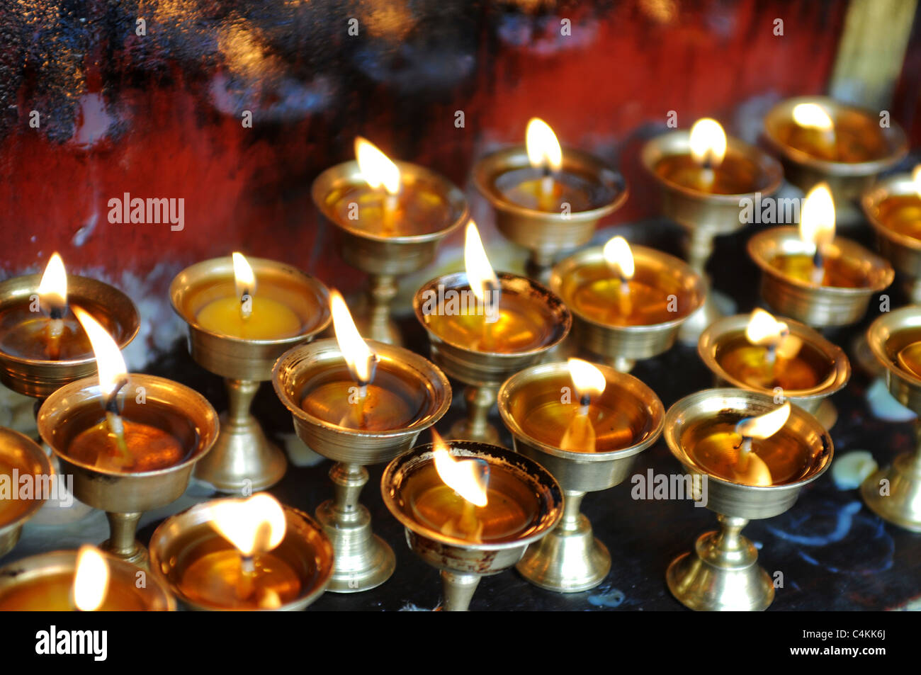 Burning yak butter lamps in a monastery, Lhasa,Tibet Stock Photo