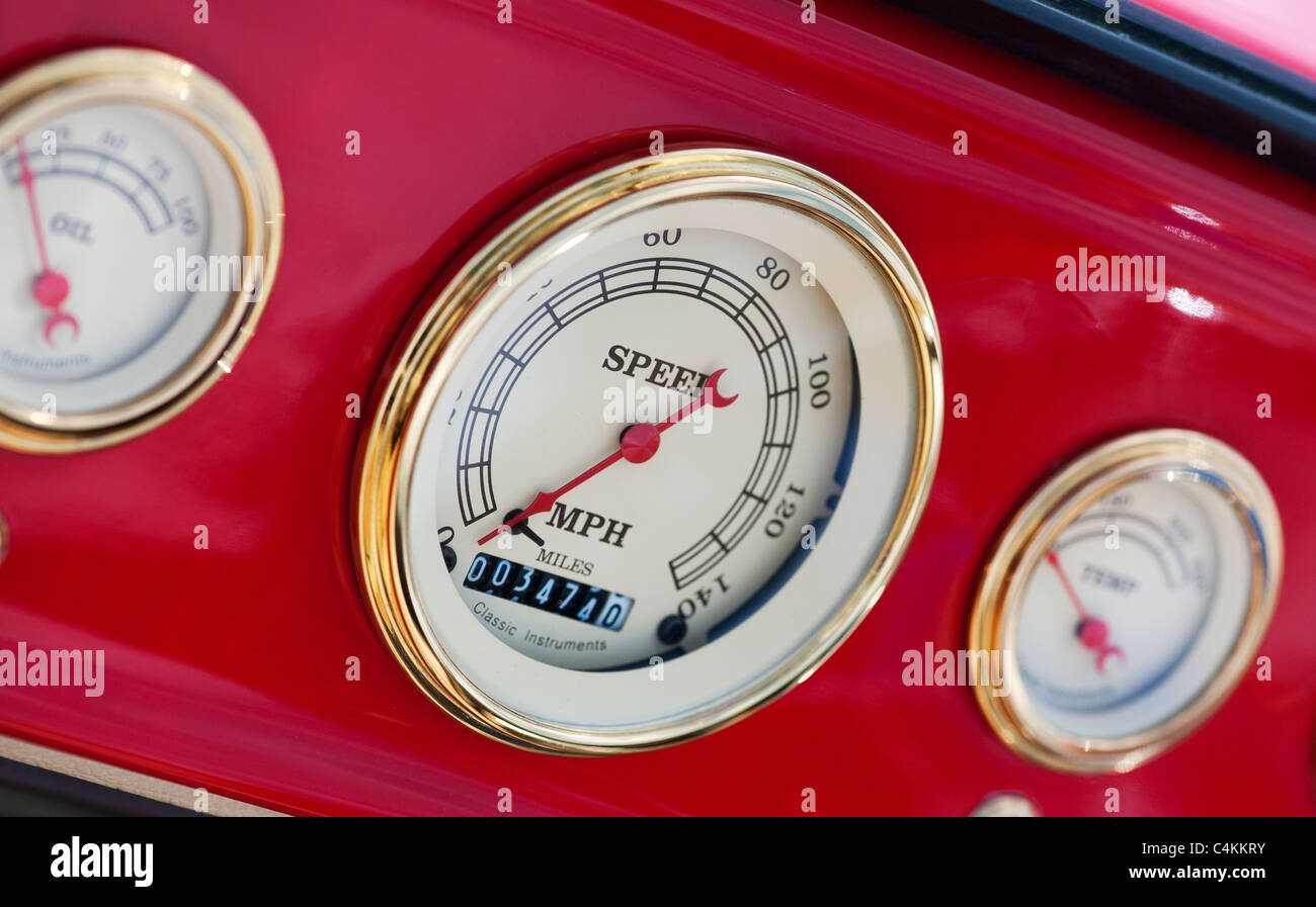 Custom red hot rod car speedometer in the dashboard detail. UK Stock Photo