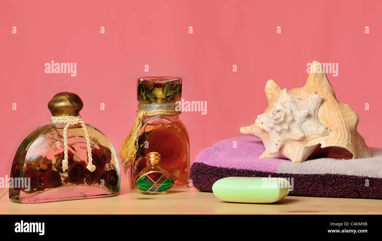 Bath oils, soap, towel, and seashell concept. Stock Photo