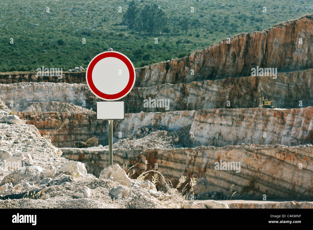 No thoroughfare sign with an open quarry behind Stock Photo