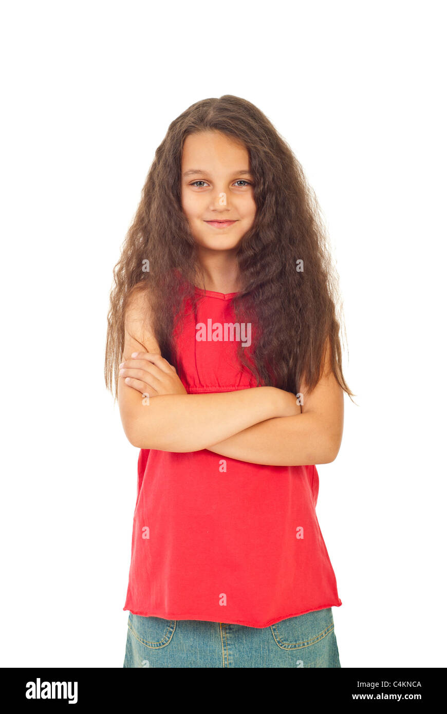Pretty girl seven years old with long curly hair standing with arms folded isolated on white background Stock Photo