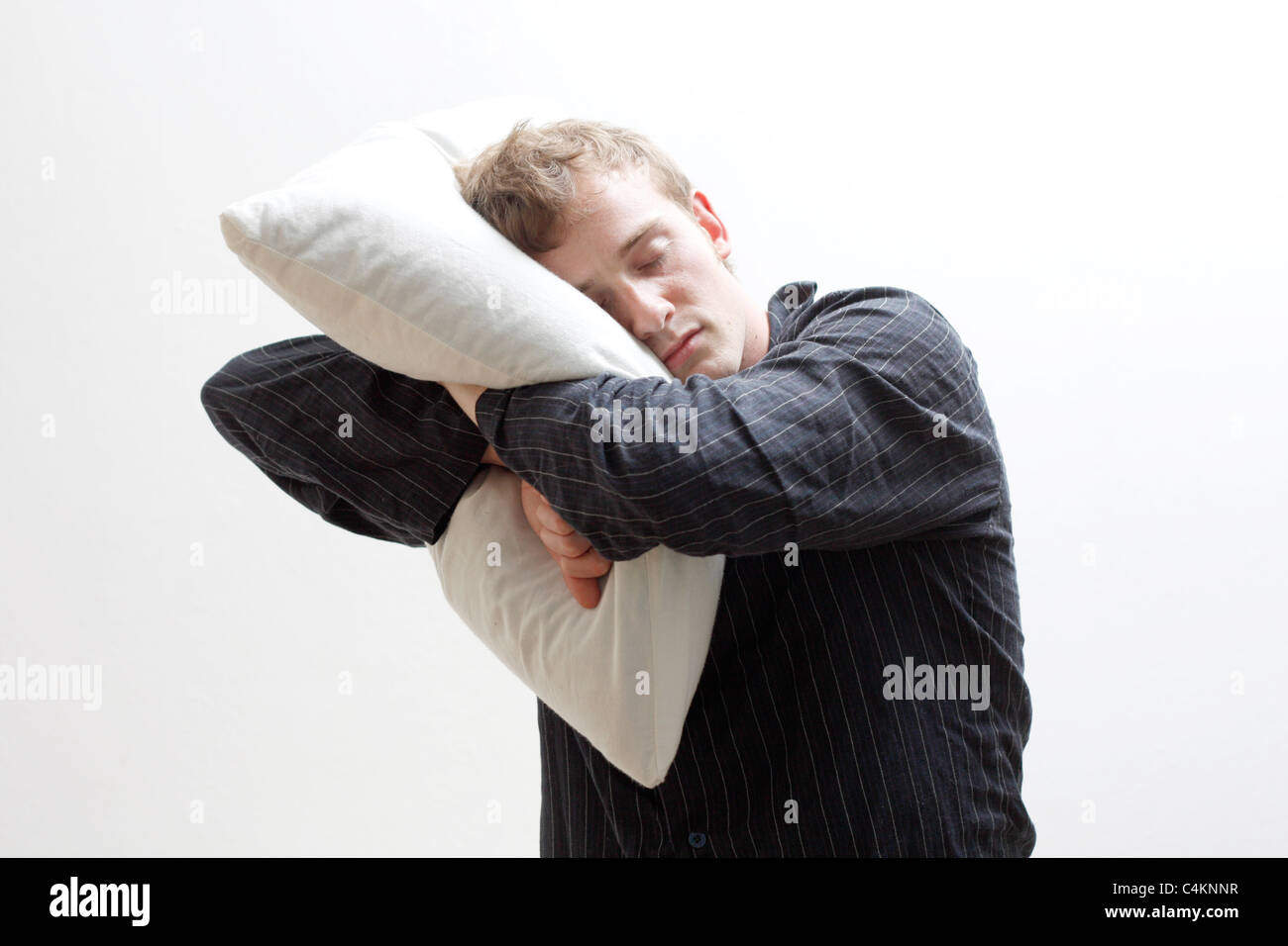 A man sleep walking with his pillow Stock Photo