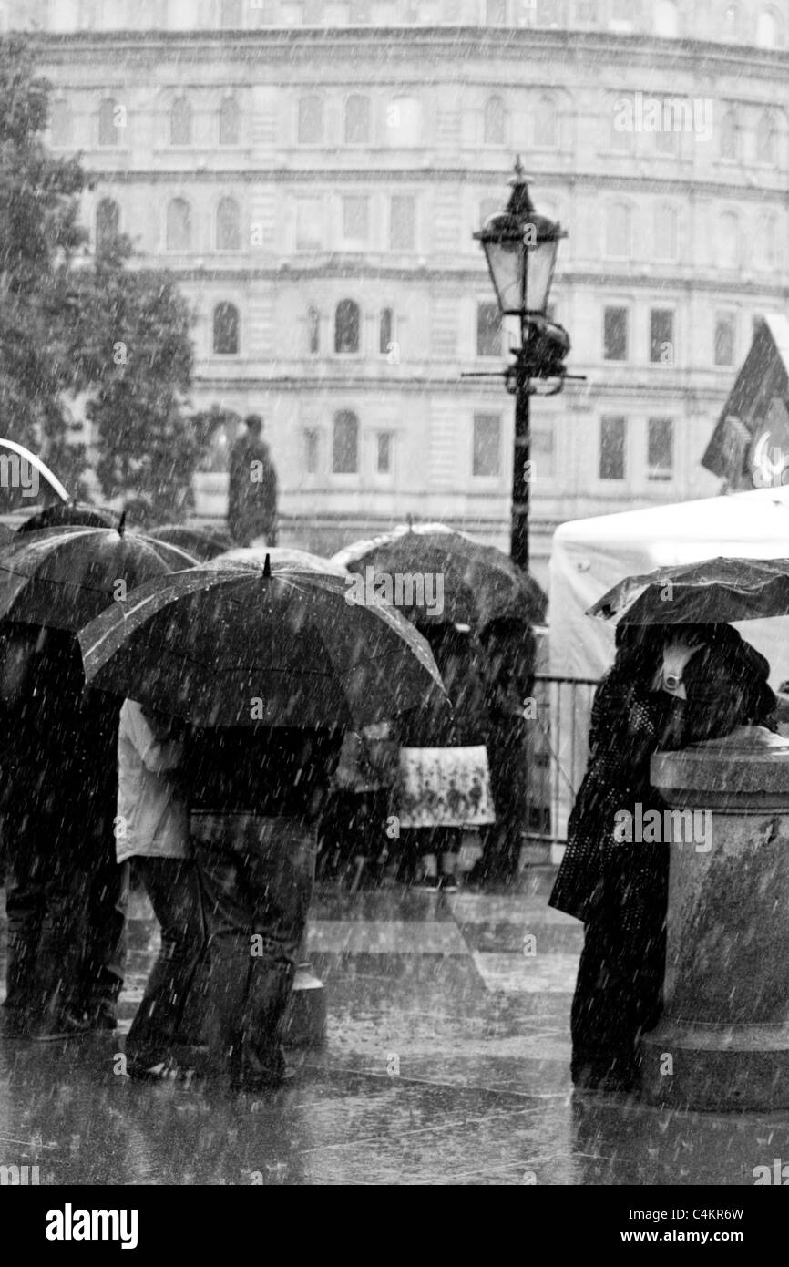 People hide from the rain in London Stock Photo