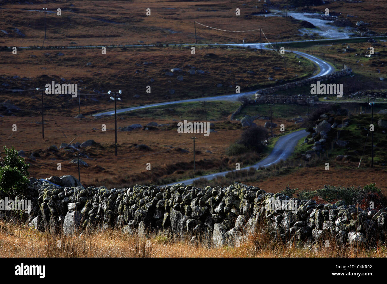 Stone Wall and Country Road Ireland Stock Photo