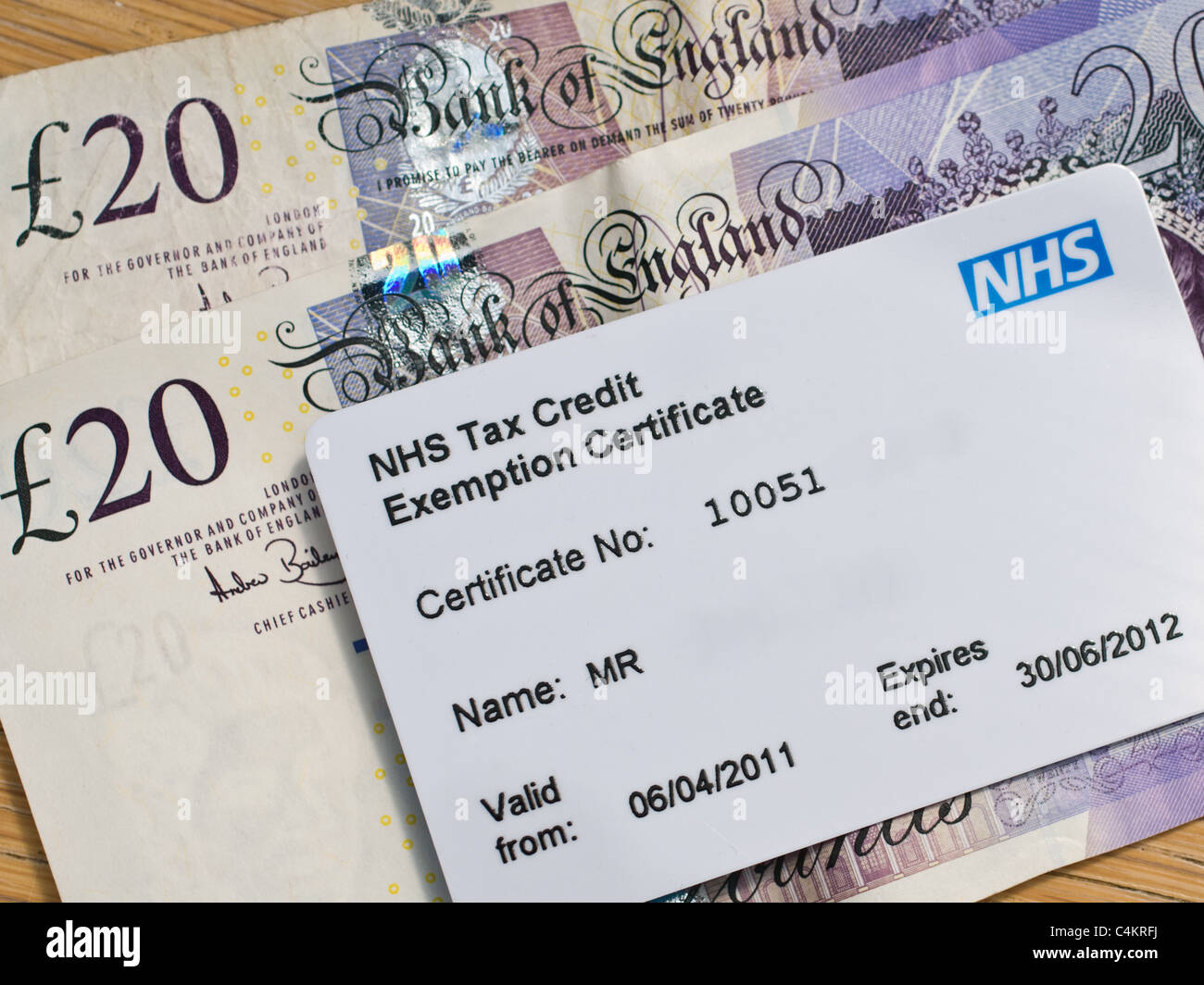 NHS Tax Credit Exemption Certificate / Card (on top of cash money) Stock Photo