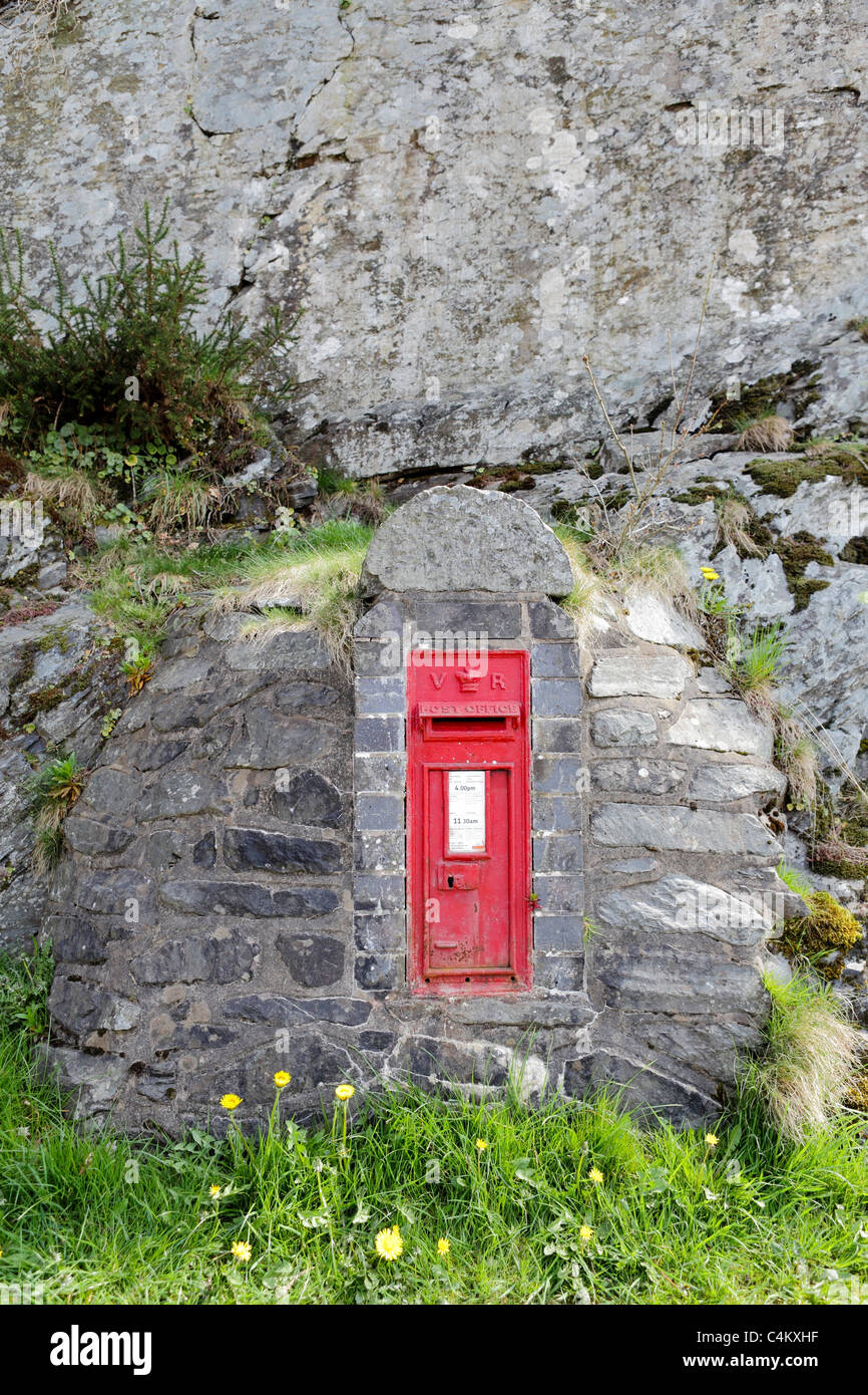RED LETTER BOX, this example is cast in stone, literally,  and was a product of the Victorian era postal service. Stock Photo