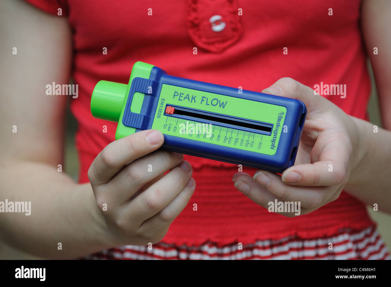 Young Asthma patient holding a Vitalograph flow meter for breath measurement Stock Photo Alamy