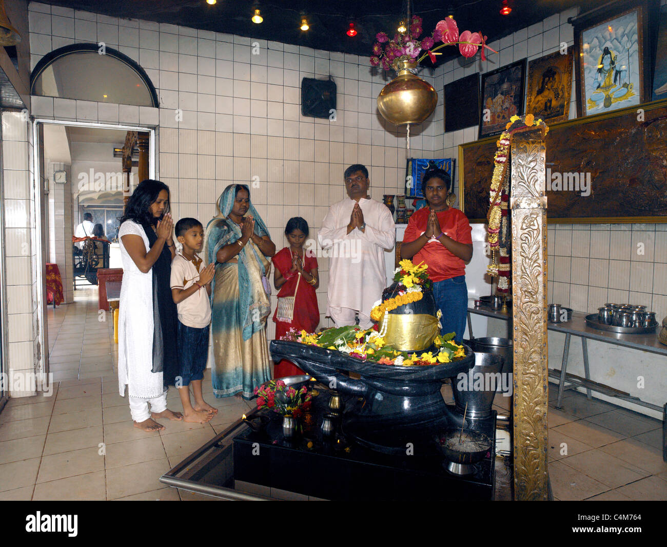 Grand Bassin Mauritius Family Praying infront of Shiva Lingum Stock Photo
