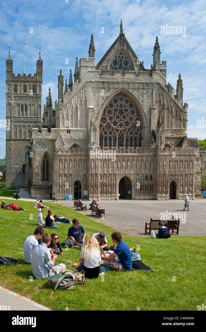 The famous West Window of Exeter Cathedral with students relaxing on