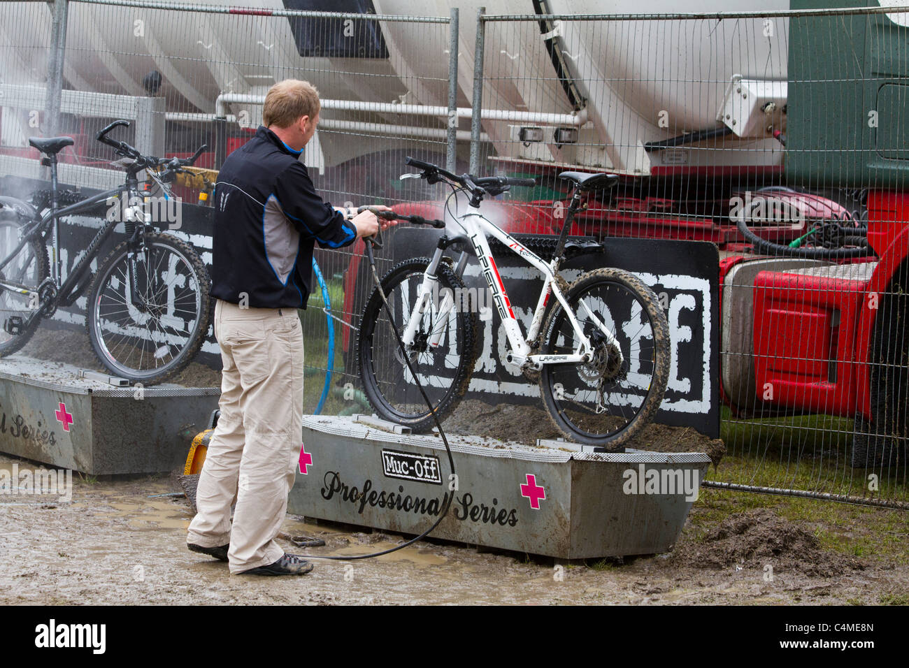 Mountain bike being washed clean of mud at the bike wash station at Mountain Mayhem 2011 Stock Photo