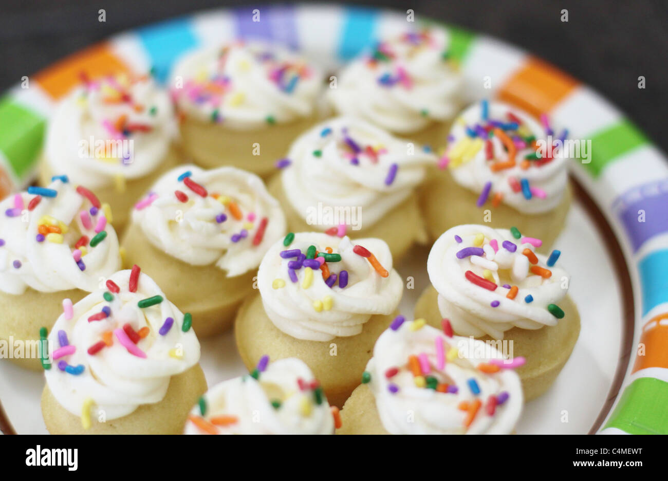 A plate of colorful mini cupcakes Stock Photo - Alamy