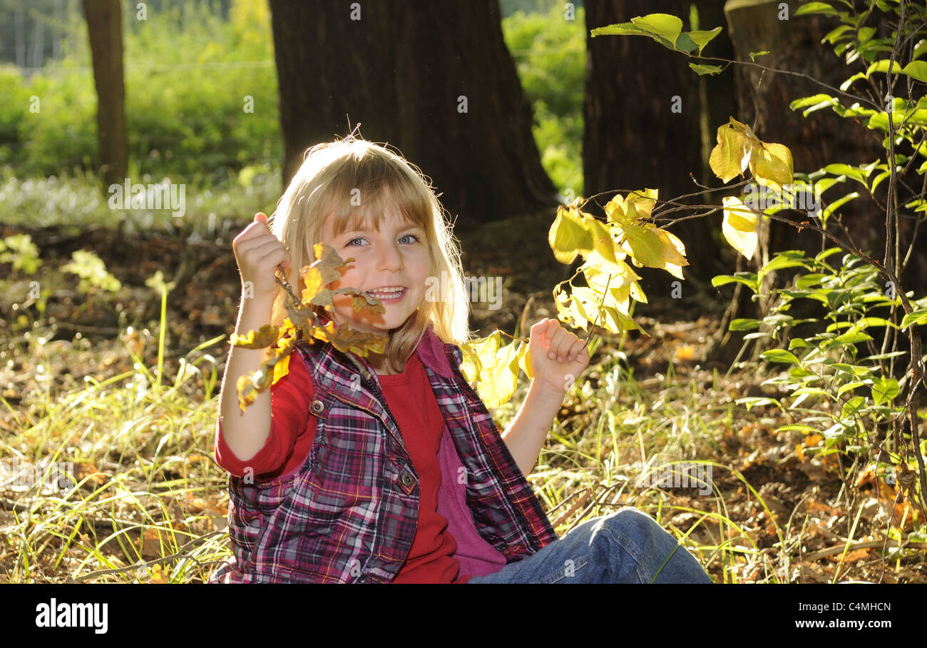 girl playing in the autumn forest Stock Photo - Alamy