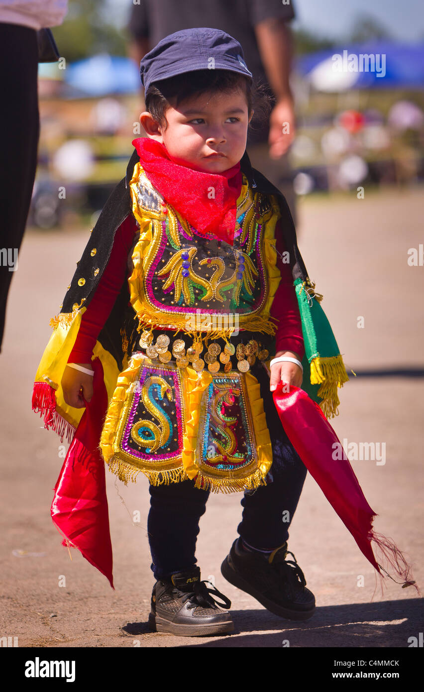 MANASSAS, VIRGINIA, USA - Young child at Bolivian folklife festival parade with dancers in costume. Stock Photo