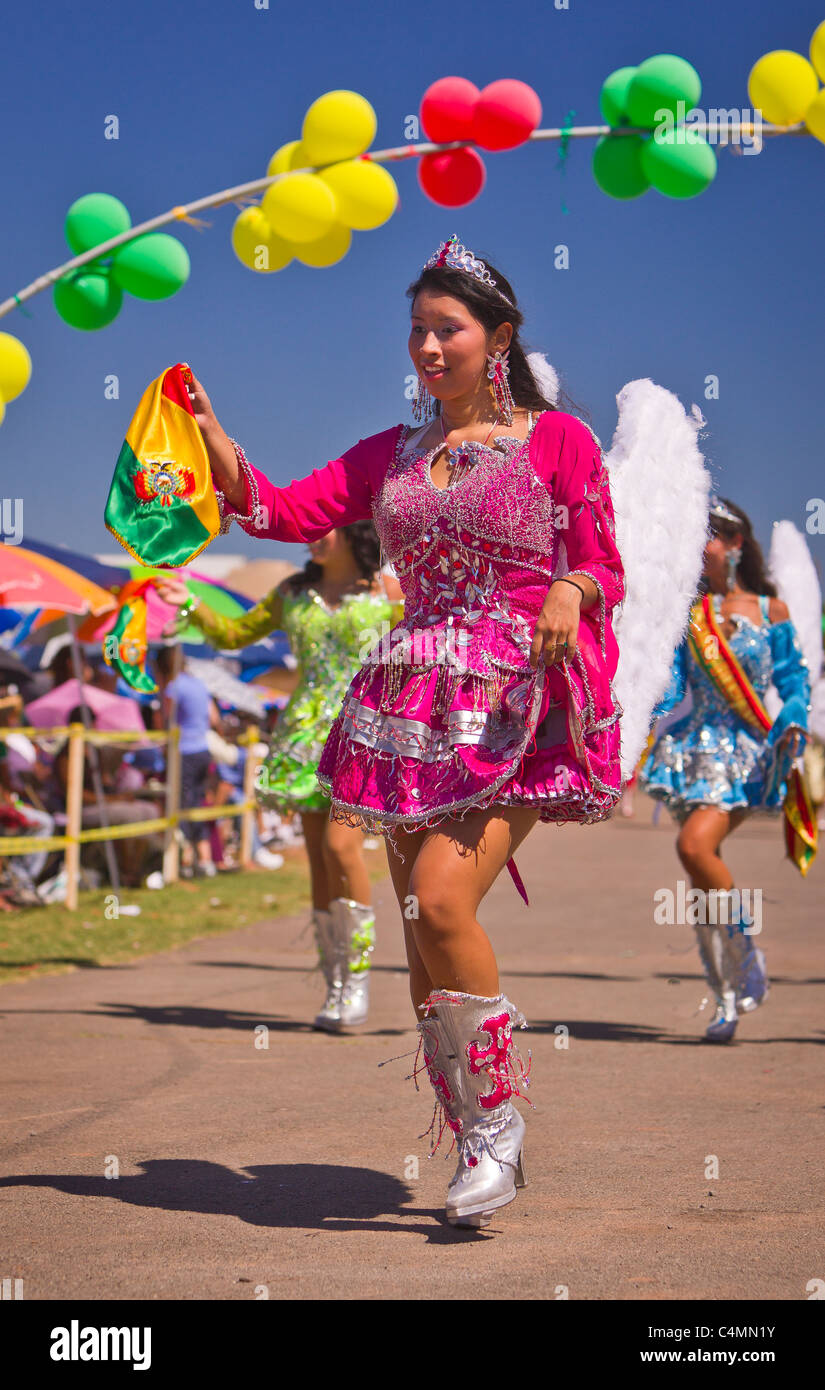 MANASSAS, VIRGINIA, USA - Woman with angel wings during Bolivian folklife festival parade with dancers in costume. Stock Photo