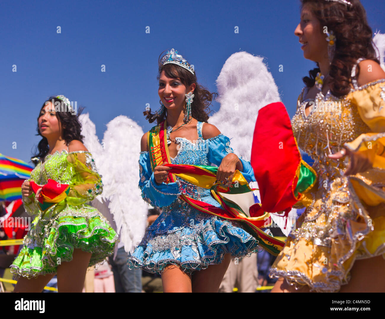 MANASSAS, VIRGINIA, USA - Women with angel wings during Bolivian folklife festival parade with dancers in costume. Stock Photo
