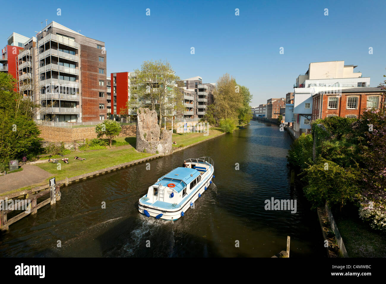 boat travelling along the river Wensum in Norwich, UK Stock Photo