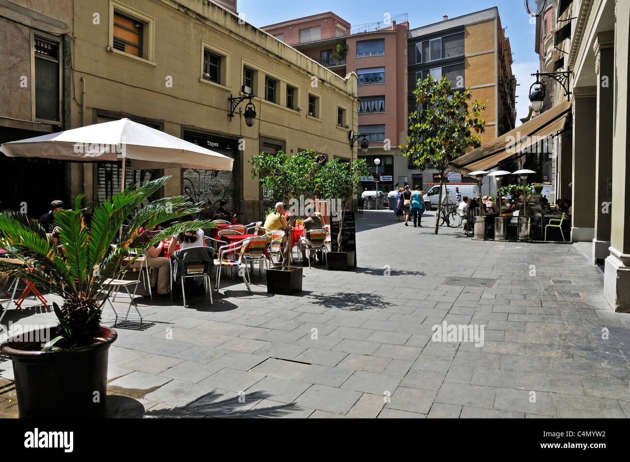 A pleasant sunny paved square where diners can eat at an outdoor restaurant in a traffic free environment Stock Photo
