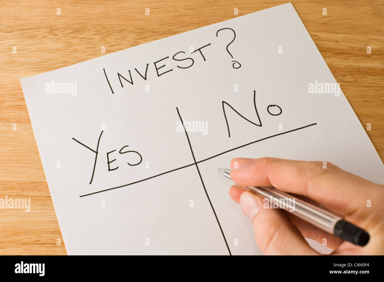 Business man making the decision of whether or not to invest Stock Photo