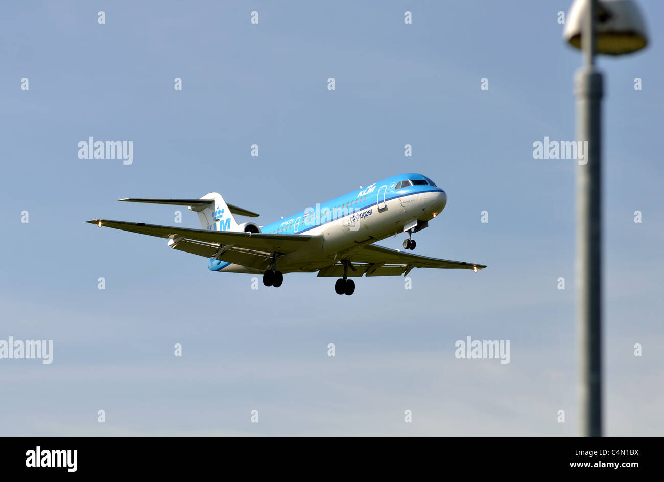 KLM Cityhopper Fokker 70 aircraft approaching Birmingham Airport, UK Stock Photo