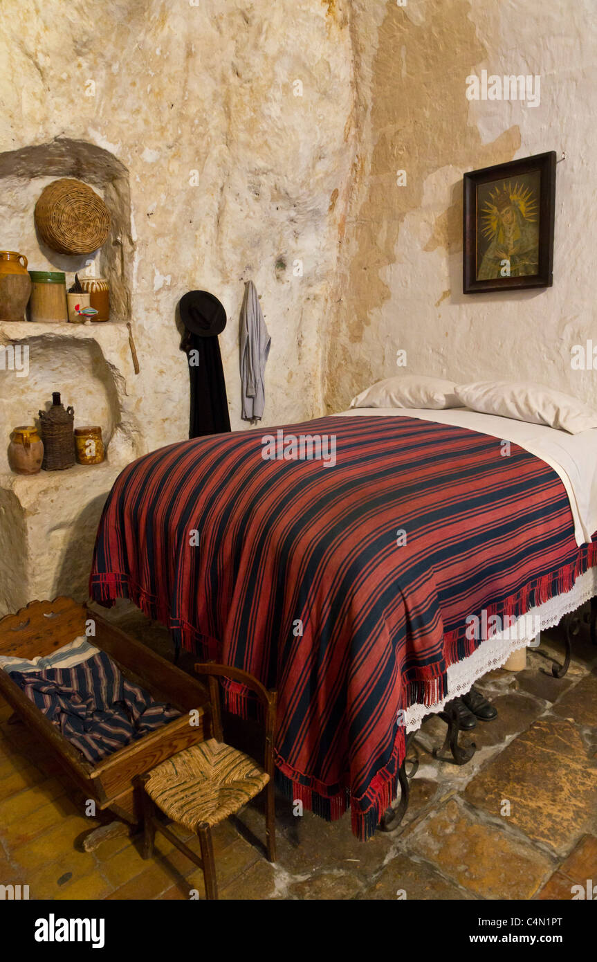 Cave house in the Sassi Caveoso of Matera. Casa Grotta di Vico Solitaro. Traditional high bed