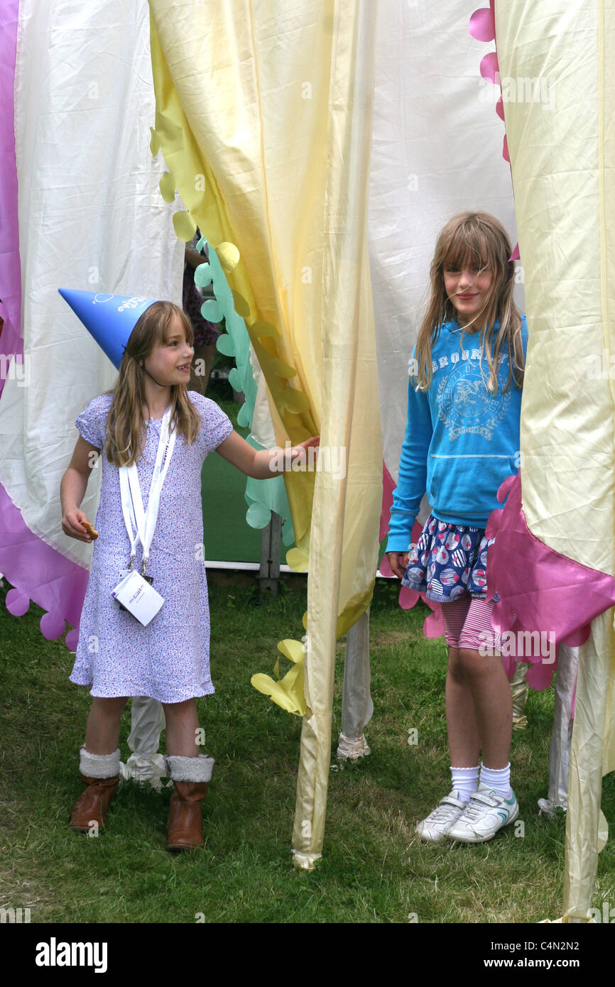 the sweetest sisters (with their father's permission, of course), posing and playing with the iconic flags at the Hay Festival Stock Photo