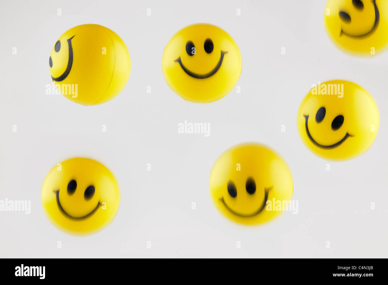 Bouncing yellow smiley face balls Stock Photo