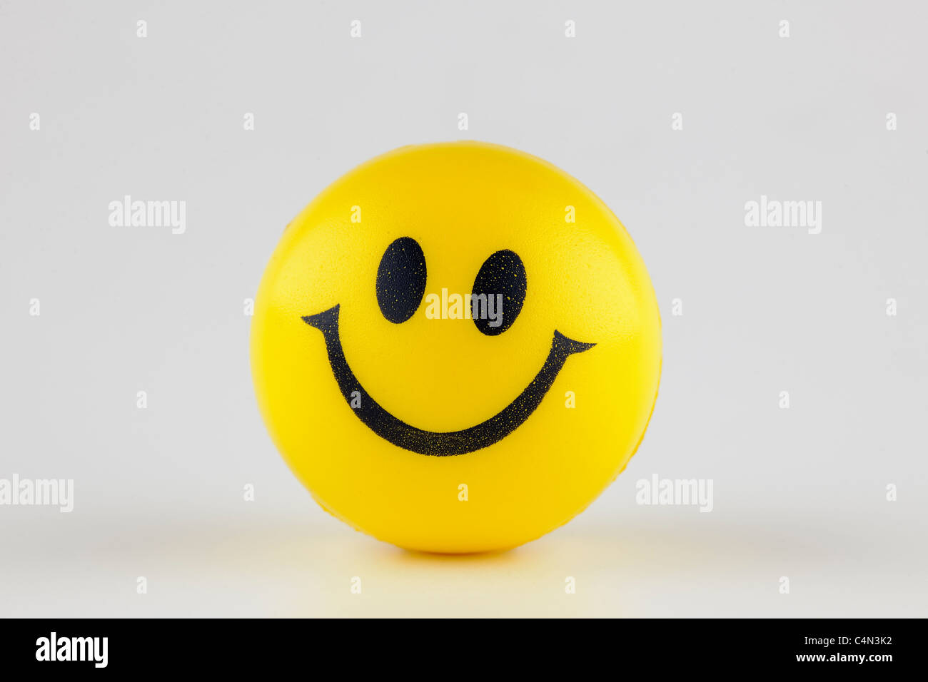 Yellow smiley rubber ball Stock Photo