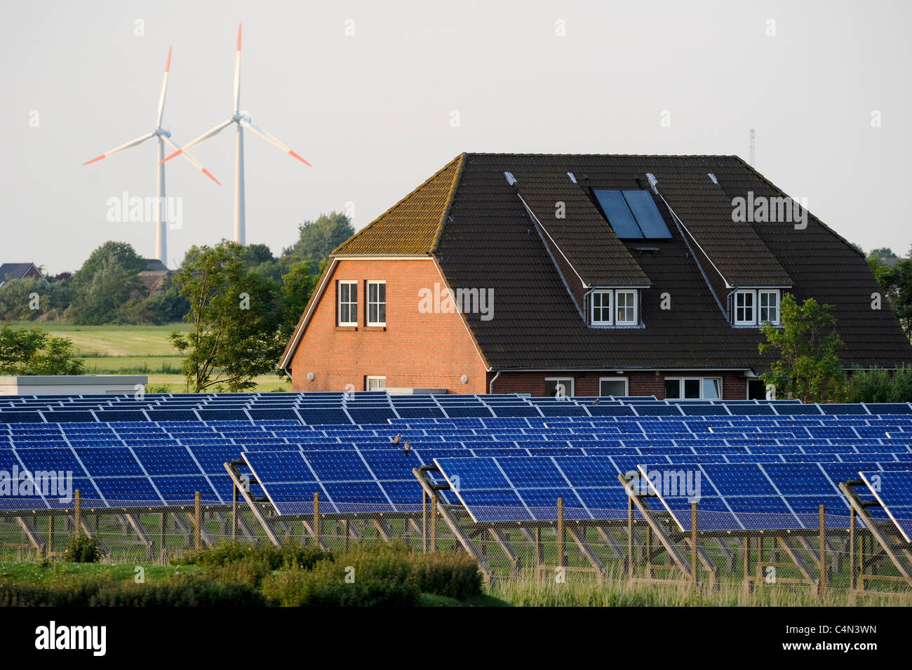 Germany , North sea island Pellworm , solar field of E-on AG and wind turbines Stock Photo