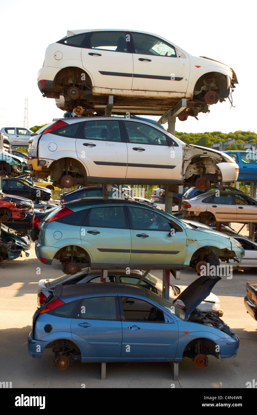 Cars stacked up in a scrapyard. Stock Photo