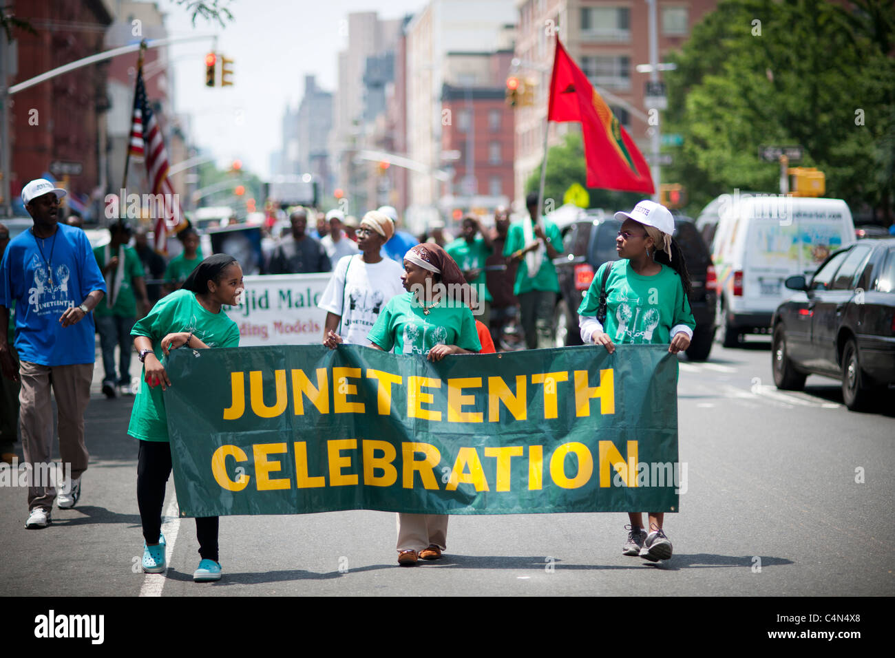 Participants march in the celebration parade through the