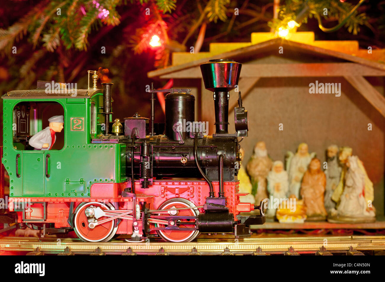 Christmas Train and Stable by Christmas Tree. Stock Photo