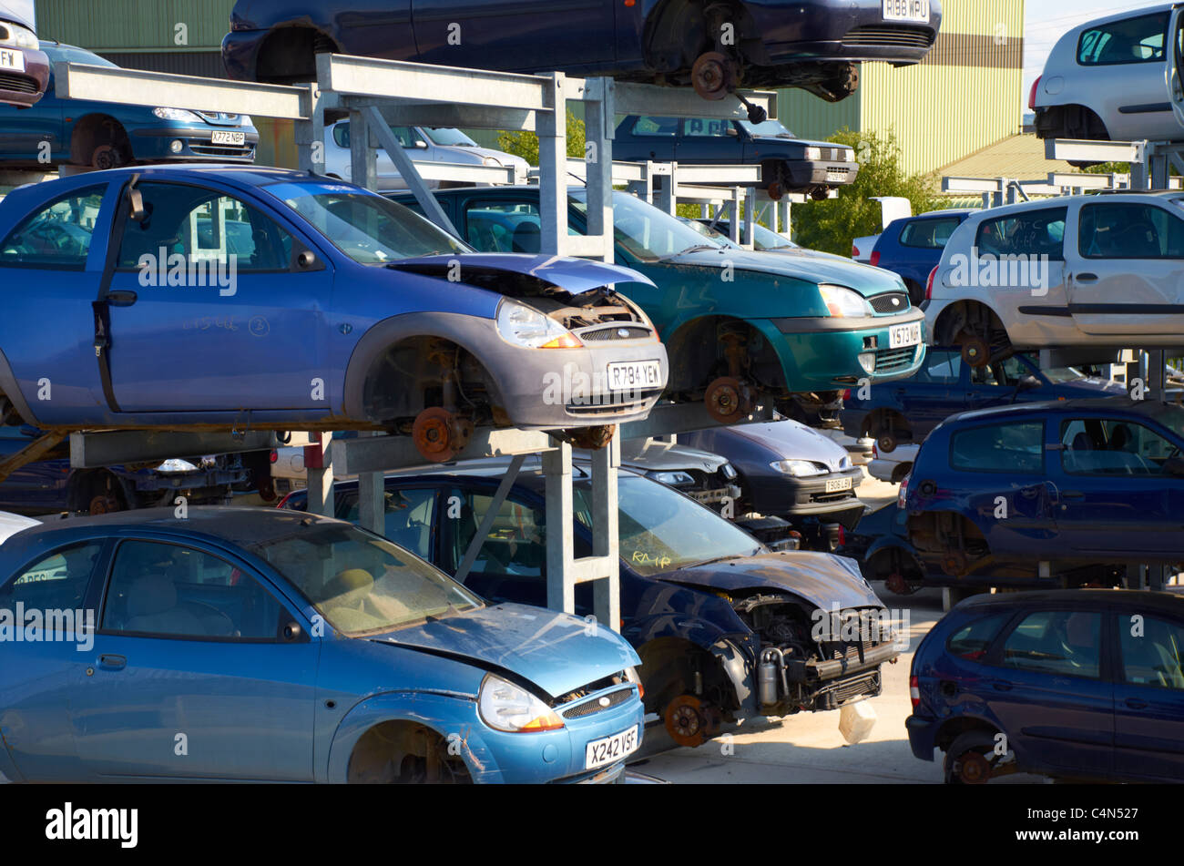 Cars stacked up in a scrapyard. Stock Photo