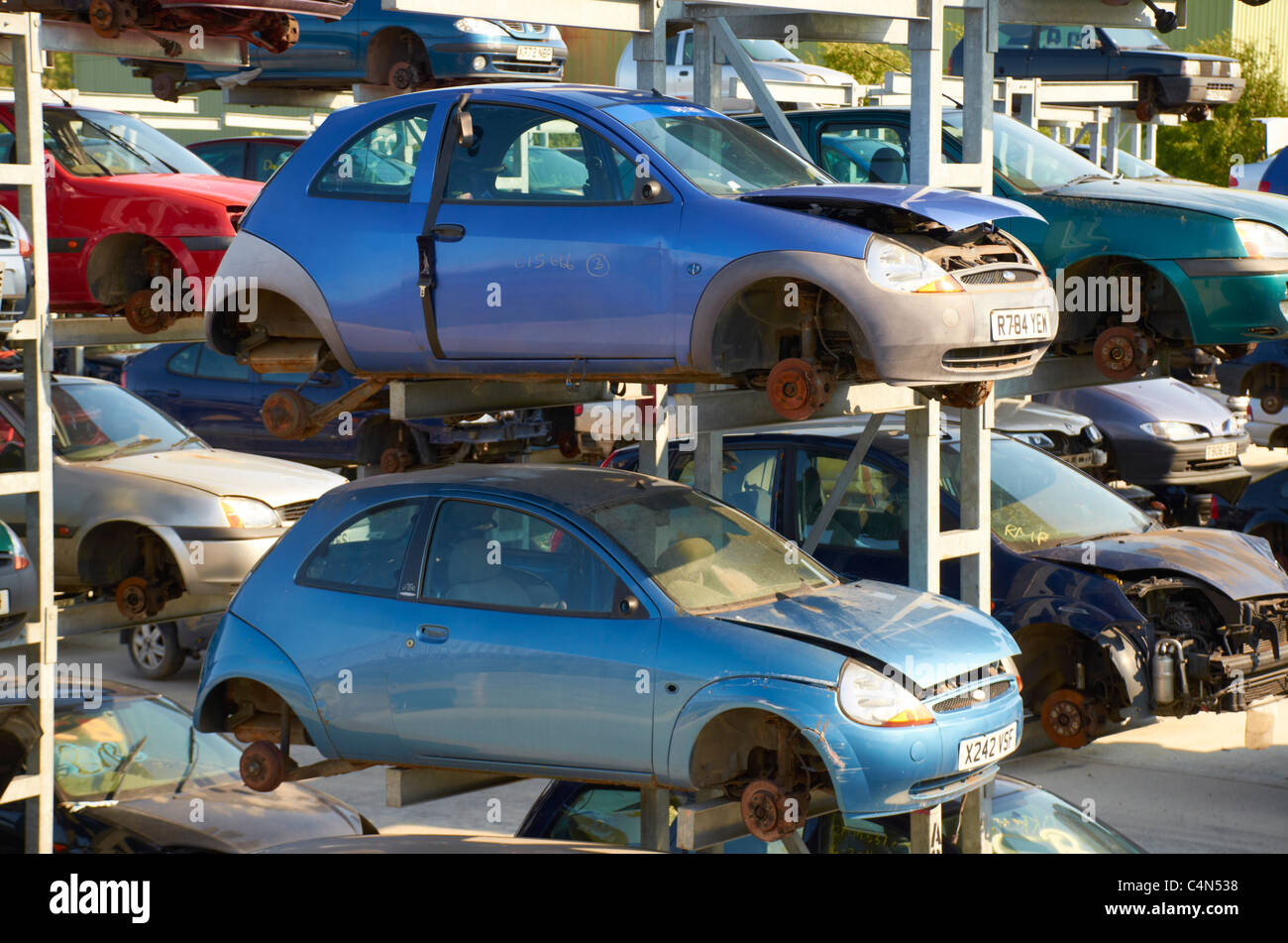 Cars stacked up in a scrapyard. Stock Photo