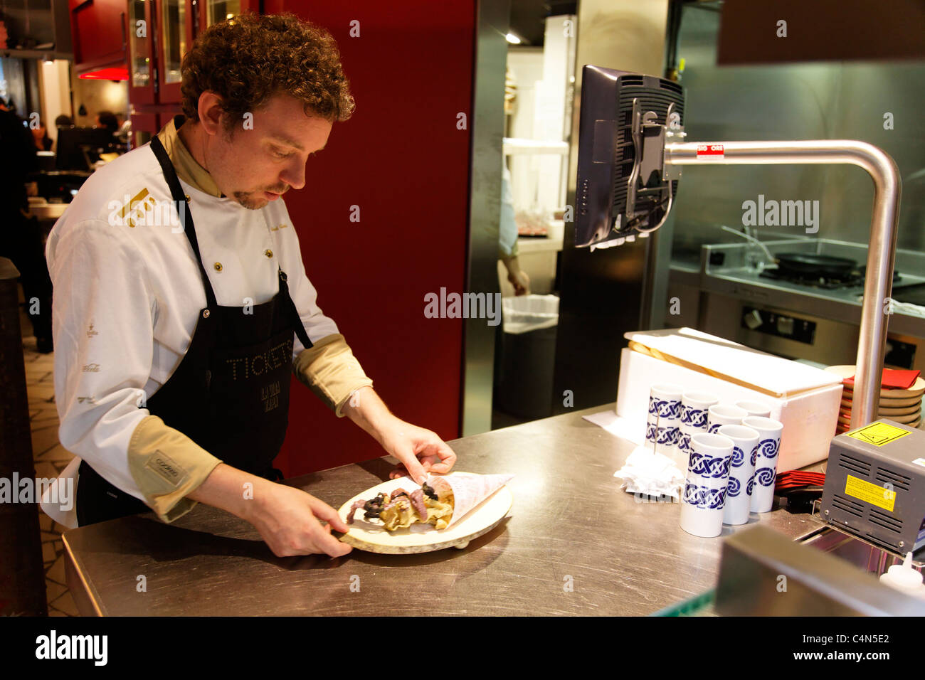 Albert Adria inspects food at his bar Tickets. Stock Photo