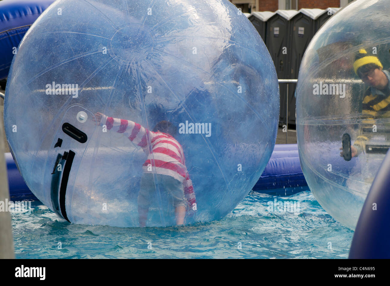 Kid inside giant Inflatable ball Stock Photo - Alamy