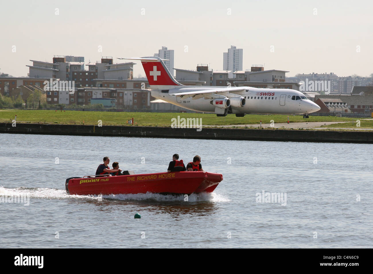Inflatable boat on River Thames alongside City of London Airport Stock Photo Alamy