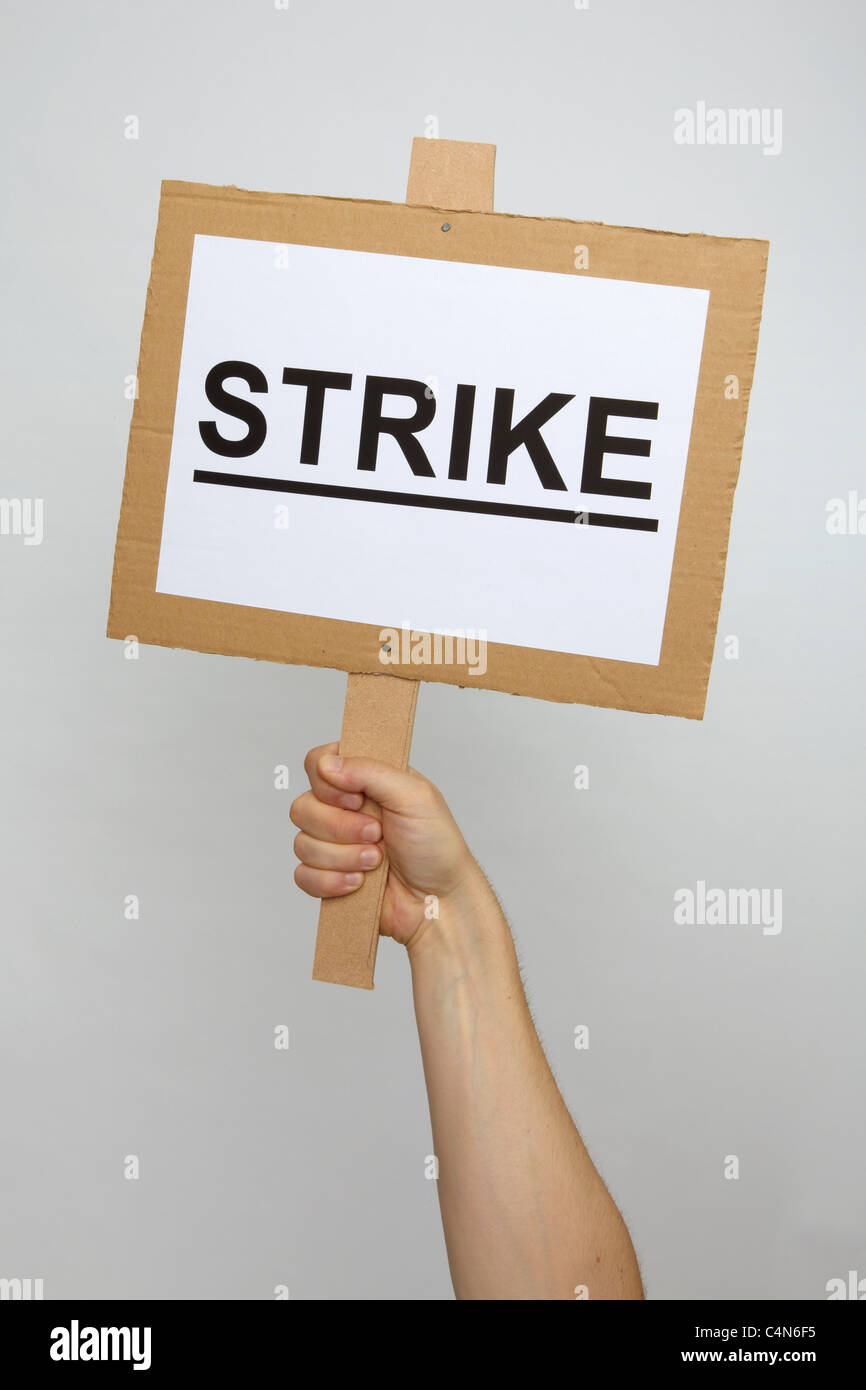 A strike placard held up by an unseen protester Stock Photo
