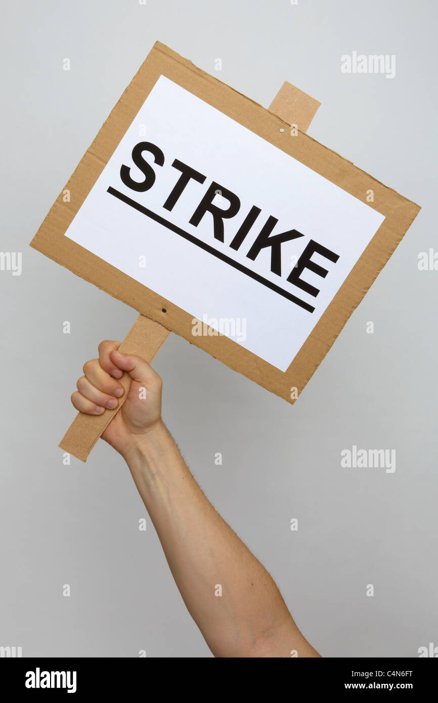 A strike placard held up by an unseen protester Stock Photo