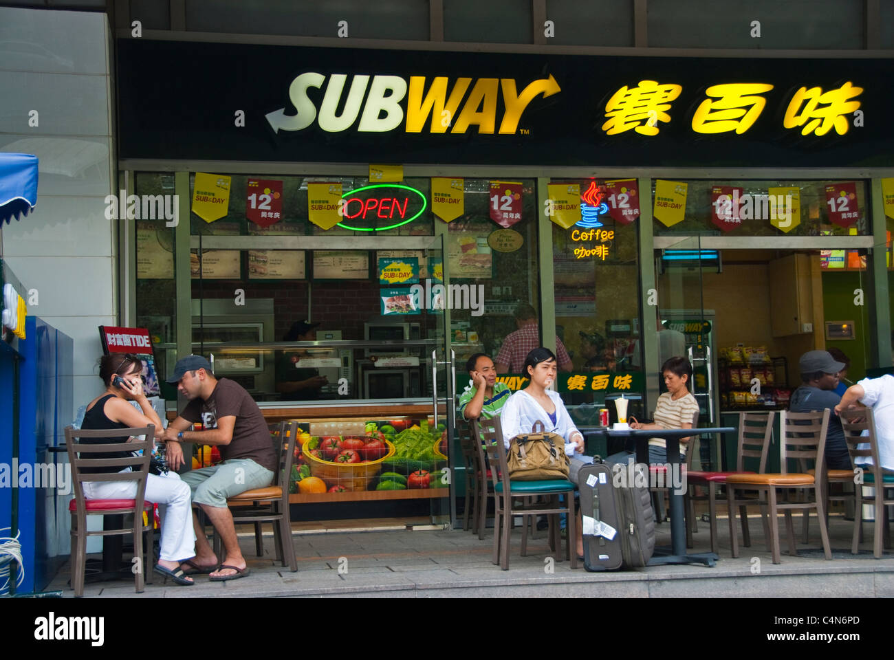 Beijing, China, Tourists Sharing Meals Outside American Fast Food Restaurant Terrace, Tables, 'Subway' ,Store Front in Diplomatic District, china capitalism Stock Photo