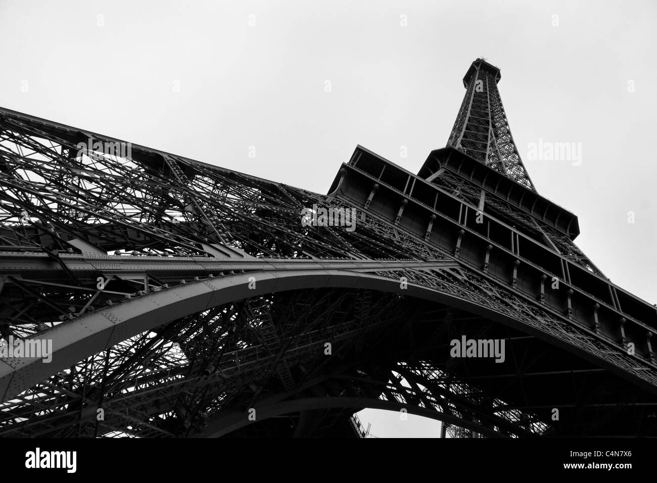 Looking up at the iconic and unmistakable Eiffel Tower, the world famous landmark in Paris, France Stock Photo