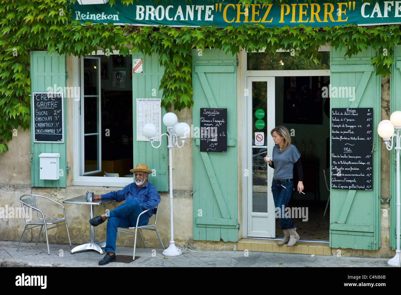 Customers at traditional French Cafe with menus in quaint town of Castelmoron d'Albret in Bordeaux region, Gironde, France Stock Photo