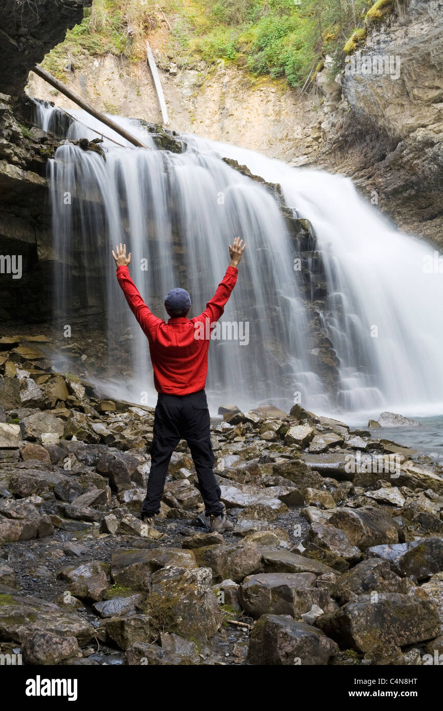 Person raised arms by waterfall hi-res stock photography and images - Alamy