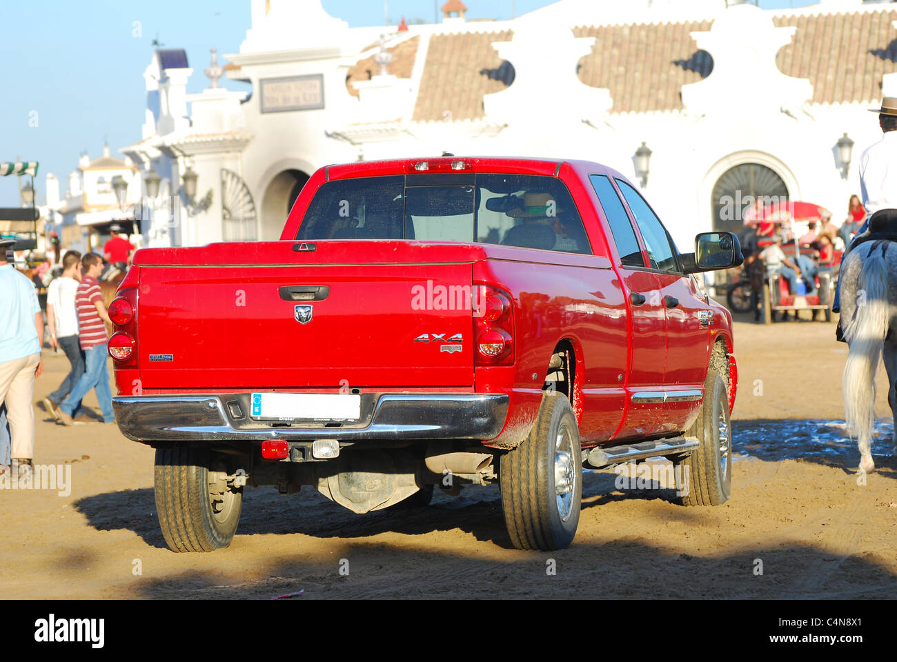 A rear view of a red pickup truck transport the pilgrimage, in the