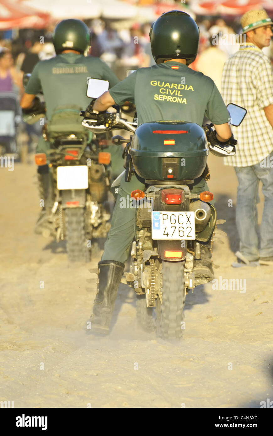 Guardia Civil Trafico police motorcycle on  patrolling the pilgrimage city el Rocio, andalusia, Spain Stock Photo