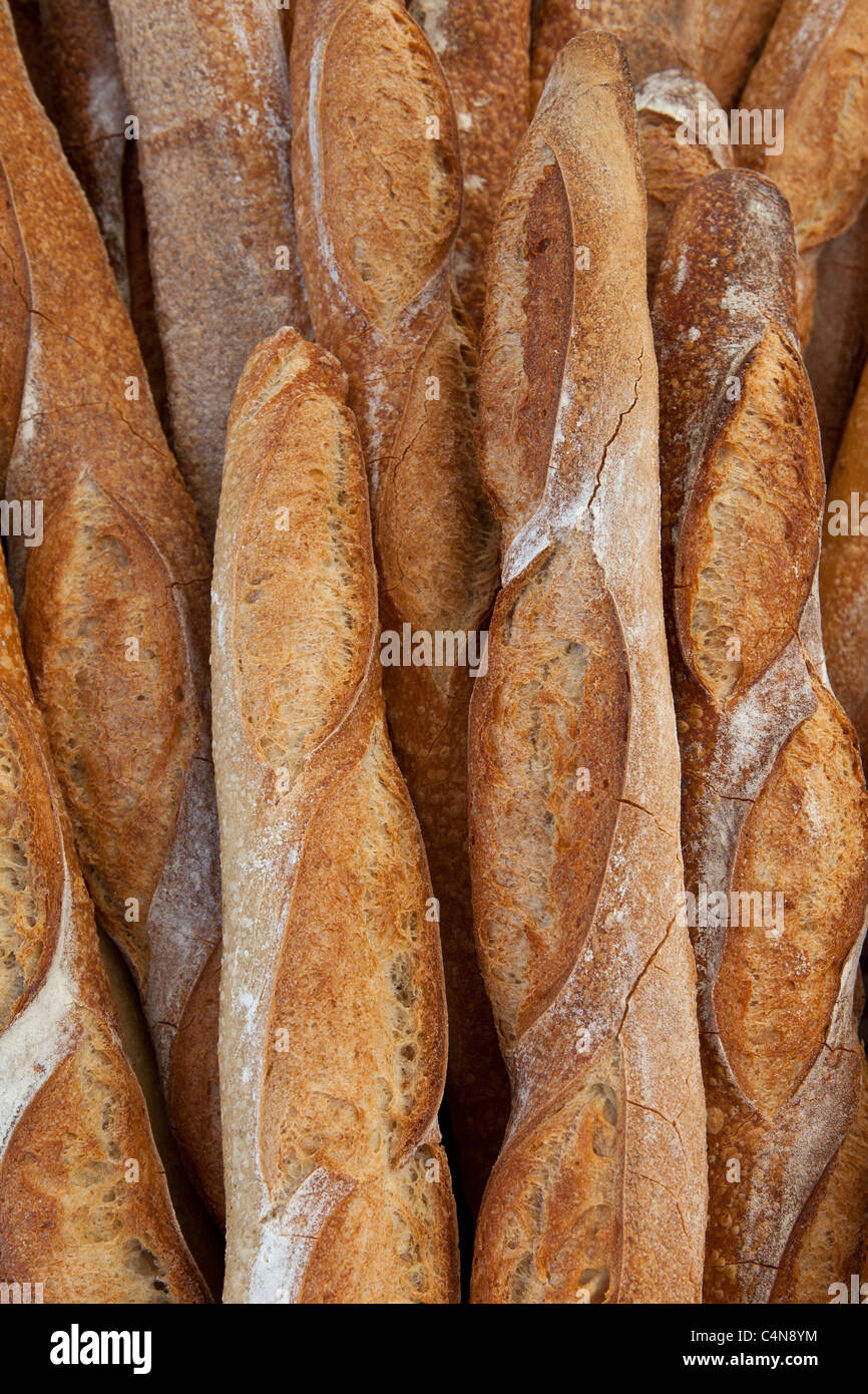 Freshly-baked French bread baguettes on sale at food market in Bordeaux region of France Stock Photo