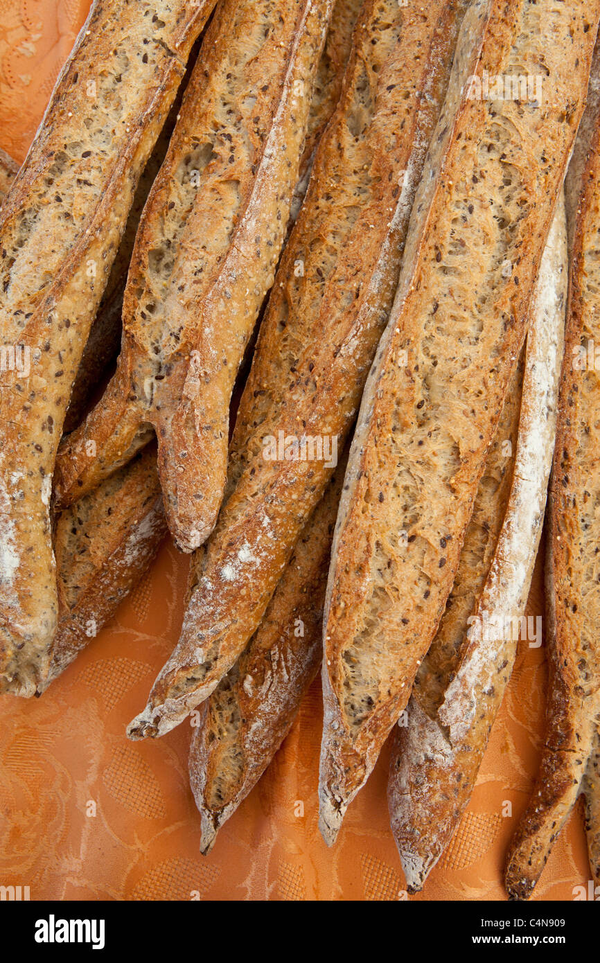Freshly-baked multigrain French bread baguettes on sale at food market in Bordeaux region of France Stock Photo