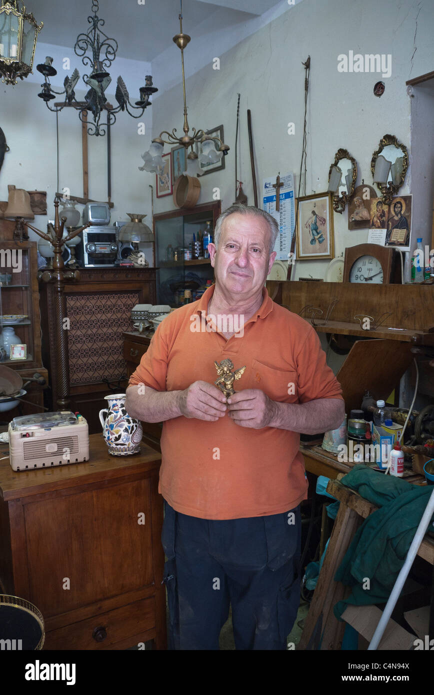 A shopkeeper in the small Italian town of Citta della Pieve, stands