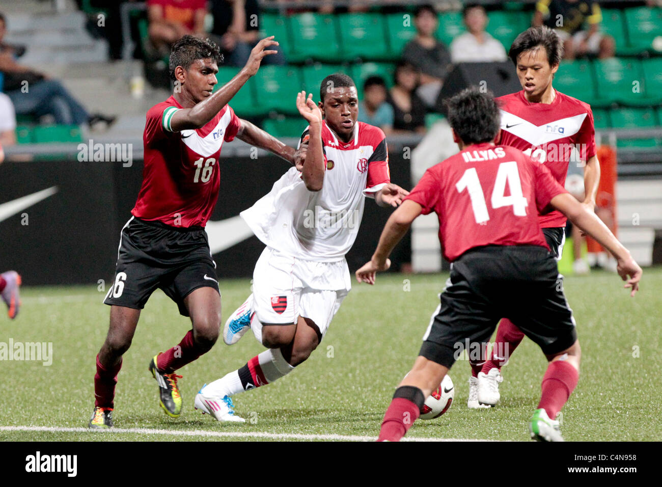 Caio Rangel of CR Flamengo U15(center) battles past Dhukhilan(left) during the 23rd Canon Lion City Cup. Stock Photo