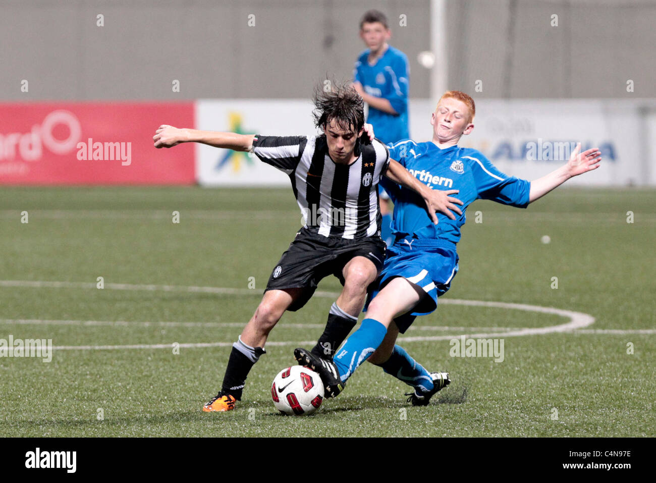 Varetto Nicholas of Juventus FC U15 attempts to hold off the challenge from Liam Gibson during the 23rd Canon Lion City Cup. Stock Photo